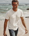 Man on the beach wearing plain white t-shirt