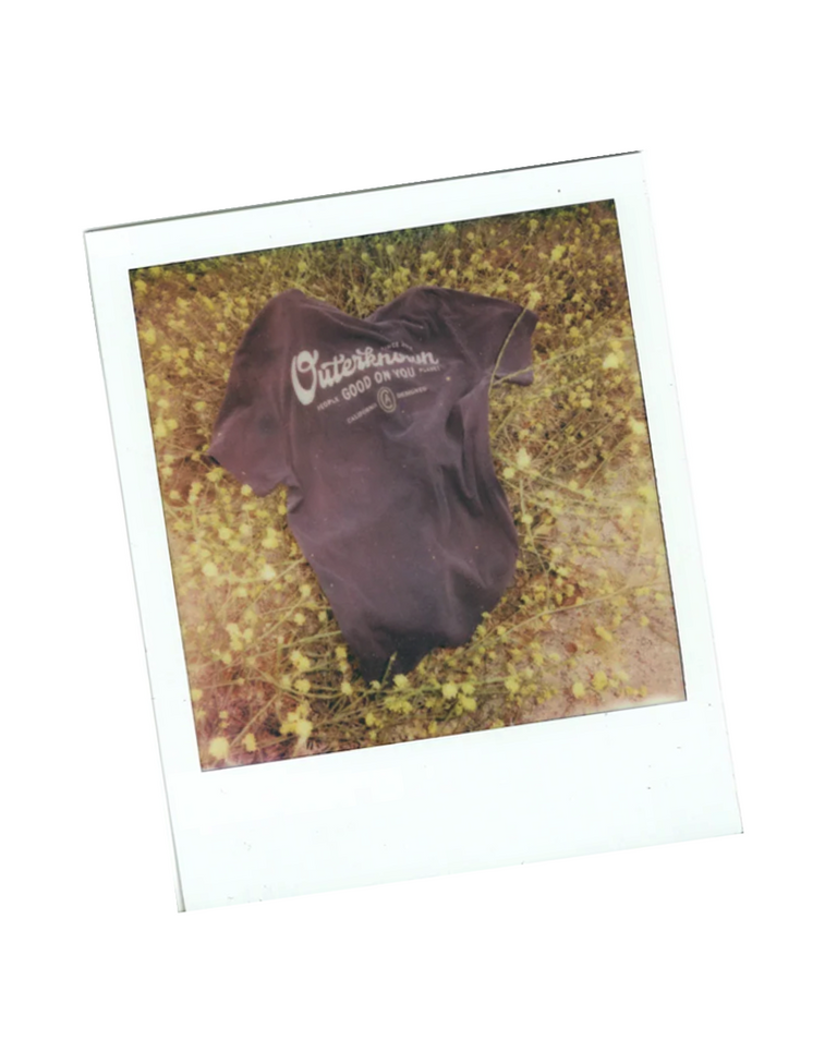 Polaroid image of an Outerknown branded t-shirt.