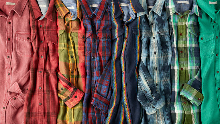 Shirts stacked along-side each other, color coded from red to green.