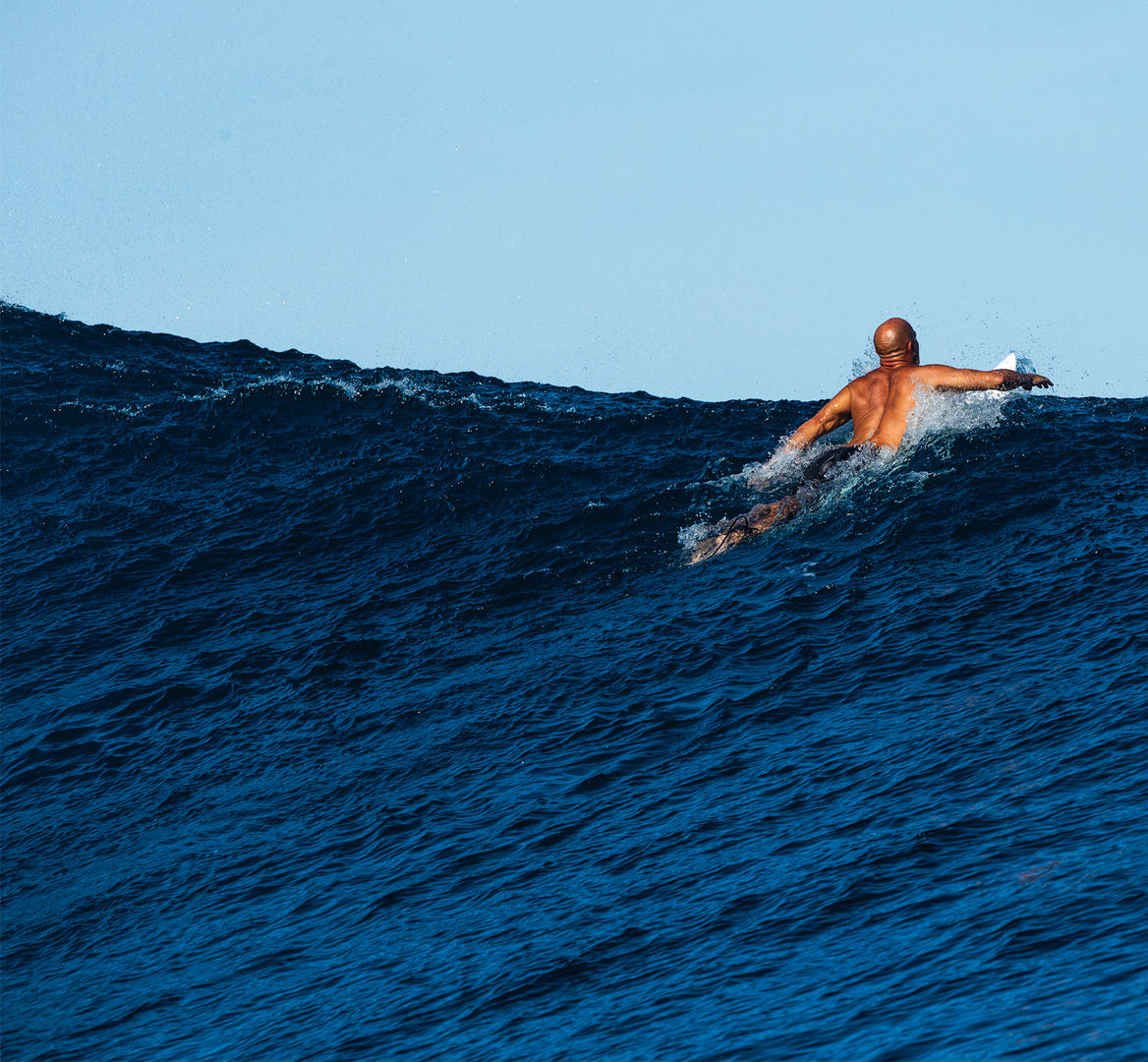 Kelly Slater riding a wave on a surfboard